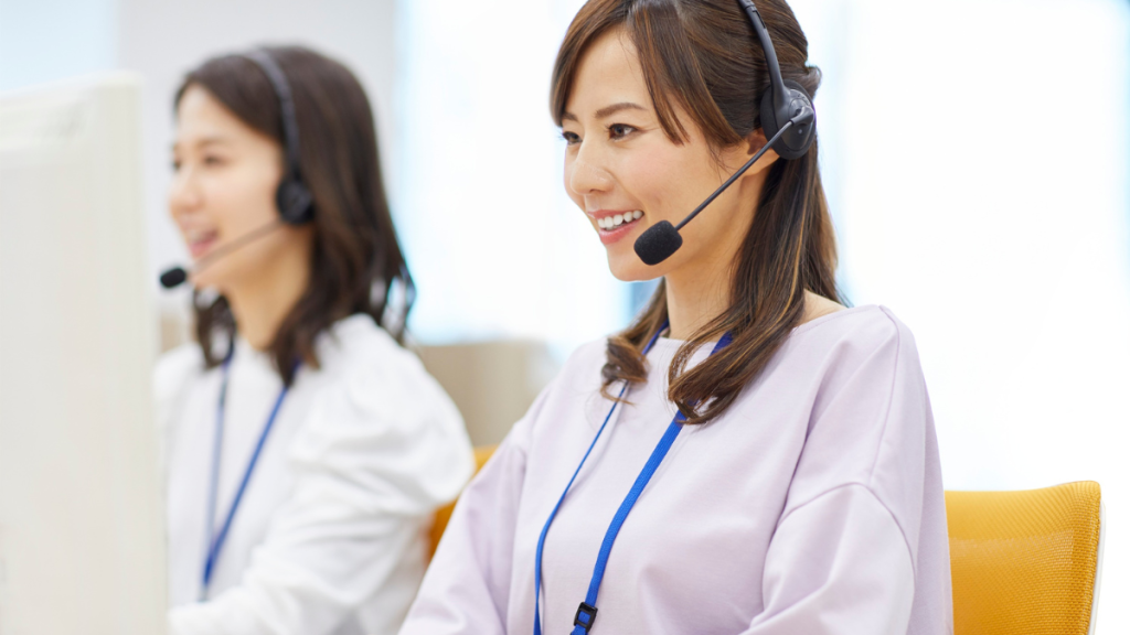 Operatrice Customer Care felice a seguito di una recensione positiva da parte di un ospite, simbolo del successo nella fidelizzazione clienti